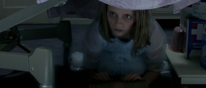 Scene in The Sixth Sense. Kyra, the dead girl, hides beneath her bed and pushes a box to Cole.